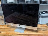 a computer monitor sitting on top of a wooden desk