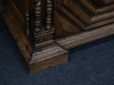 a close up of a bed with a wooden headboard