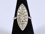 a close up of a diamond ring on a black ring stand