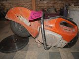 an orange and black motorcycle with a pink sign on it