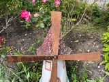 a statue of a windmill in the middle of a garden