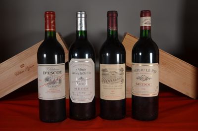 three bottles of red wine are lined up on a table