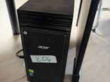 a small black computer sitting on the floor in a room