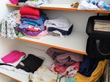 a shelf with many different types of clothing on it