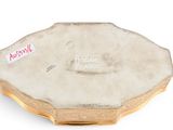 an image of a gold plate with a picture of a woman on it