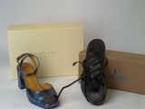 pair of black and blue shoes and a box on a white surface