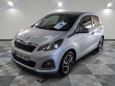 the small silver car is parked in a large room