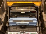 a tool box with a printer and other items in it