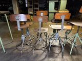 four stools that are sitting in the middle of a room