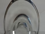 a silver plate with a metal holder on it
