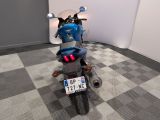 a motorcycle that is parked in a room with a checkered floor