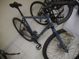 a bike that is parked in a room next to a bag