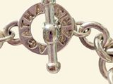 a close up of a chain bracelet with a clasp on it