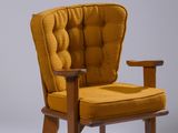 an image of a yellow chair with a wooden frame and arm rest