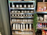 a shelf of candles and candles on display in a store