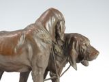 a bronze statue of two dogs standing next to each other