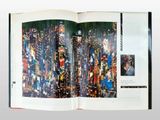 an open book with a picture of a city on it