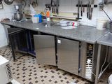 a kitchen with a sink, stove, and refrigerator in it