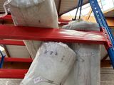 a large pile of bags sitting on top of a metal rack