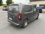 a grey van that is parked in a parking lot