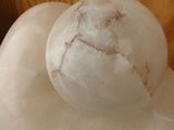 a white marble ball sitting on top of a wooden table