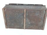an old metal box sitting on top of a white surface