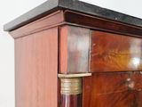 a close up of a wooden cabinet with a marble top