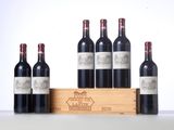 four bottles of red wine in a wooden crate with a white background