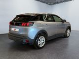 the rear of a silver car is parked in a garage
