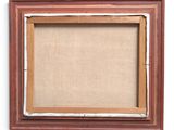 an old picture frame with a piece of burlock on it
