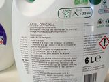 a bottle of liquid sitting on a counter next to a bottle of liquid