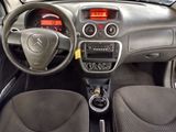 a dashboard of a small car with a clock on the dash
