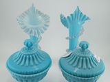 deux vases en verre bleu posés sur une table blanche