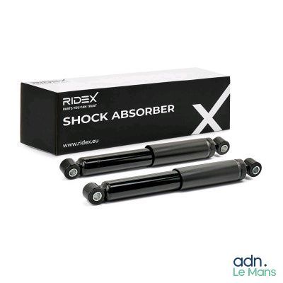 a pair of black shock absorbs in front of a box
