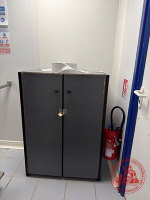 a black cabinet in the corner of a room