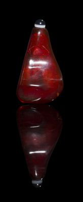 an image of a red glass vase on a black surface