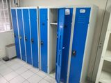 several blue lockers are lined up in a row in a room