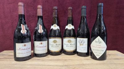 six bottles of wine are lined up on a wooden table