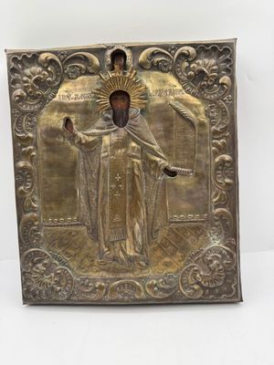 une plaque métallique représentant Jésus tenant une croix