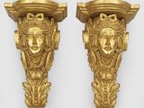 paire de supports muraux en or doré, ornés de visages de chaque côté