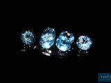 a group of three blue diamonds sitting on top of a black surface