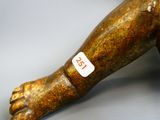 a wooden statue of a foot with a sticker on it