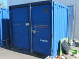 a blue container sitting in the middle of a parking lot