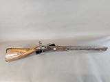 an old gun with a wooden handle on a white background