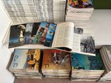 a lot of books that are stacked up on a table