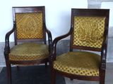 two chairs sitting next to each other on a checkered floor