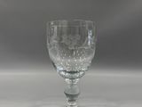 an empty wine glass sitting on top of a white table