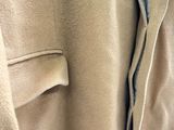 a close up of a beige coat with a zipper