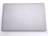 dell laptop computer sitting on a white surface with a dell logo on the screen