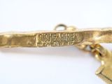 an image of a close up of a gold tie bar with a star on it